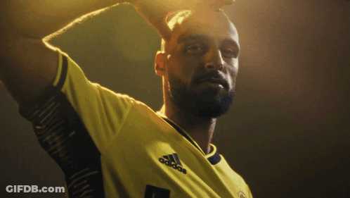 Two Soccer Players Standing Next To Each Other GIF