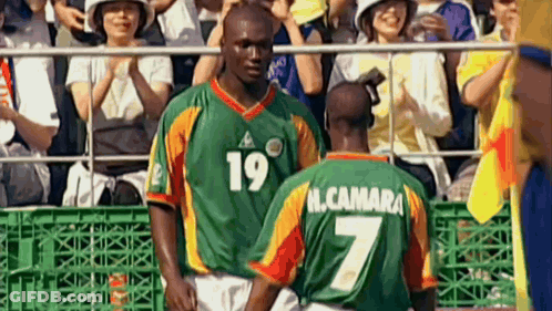 Two Soccer Players Standing Next To Each Other With One Wearing A Number 7 Jersey GIF