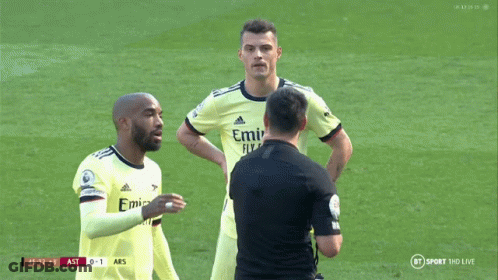 Two Soccer Players Talk Referee In Emirates Jerseys GIF