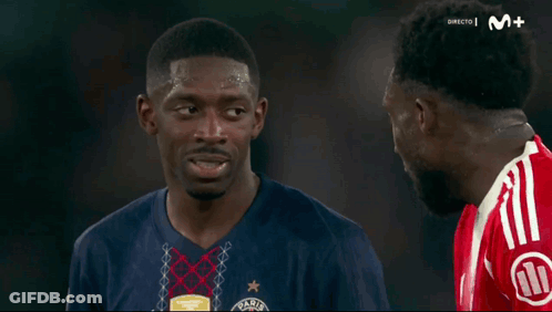 Two Soccer Players Talking On Soccer Field GIF