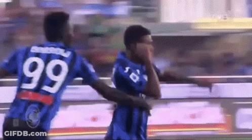 Two Soccer Players Wearing Blue Jerseys With The Number 99 On The Back GIF
