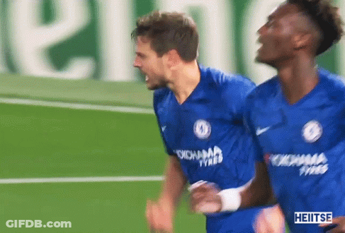 Two Soccer Players Wearing Blue Jerseys With Yokohama Tyres On The Front GIF