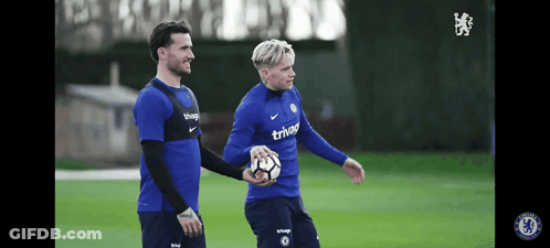 Two Soccer Players Wearing Blue Shirts That Say Trivago GIF