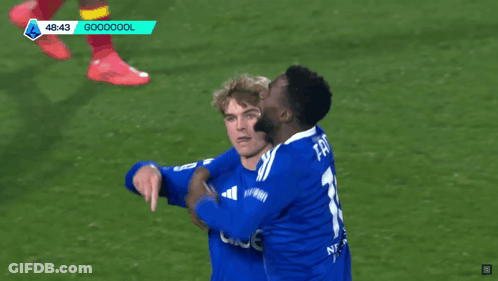 Soccer Players Hugging In Blue Jerseys GIF