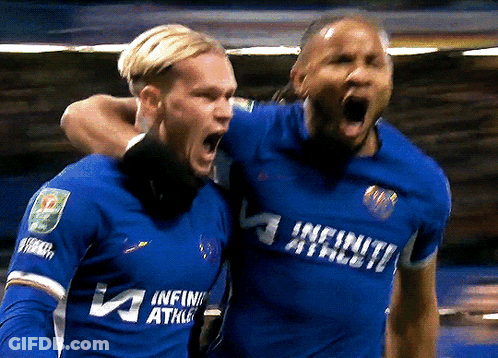 Two Soccer Players Wearing Blue Uniforms That Say Infinity Athlete GIF