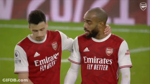 Two Soccer Players Wearing Emirates Fly Better Jerseys Are Hugging GIF