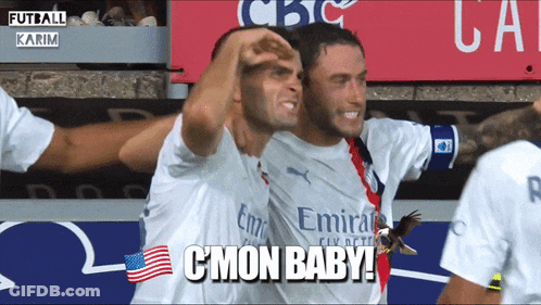 Two Soccer Players Wearing Emirates Jerseys Are Hugging Each Other GIF