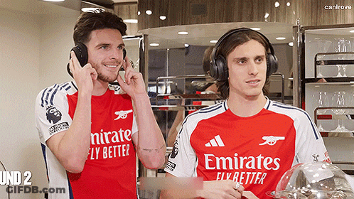 Two Soccer Players Wearing Emirates Shirts GIF