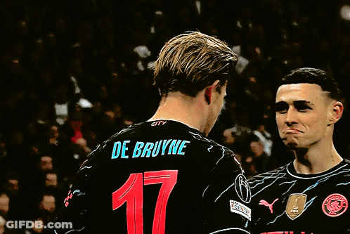 Two Soccer Players Wearing Etihad Jerseys Are Talking GIF