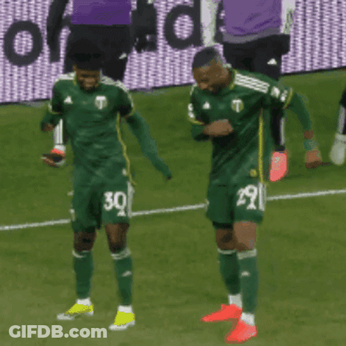 Two Soccer Players Wearing Green Jerseys With The Number 30 And 29 GIF