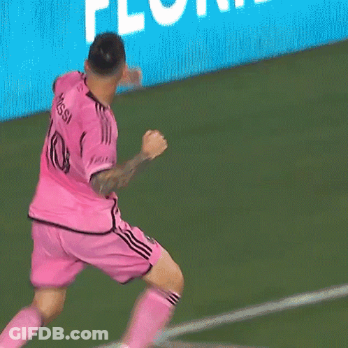 Two Soccer Players Wearing Pink Jerseys Hugging Each Other GIF