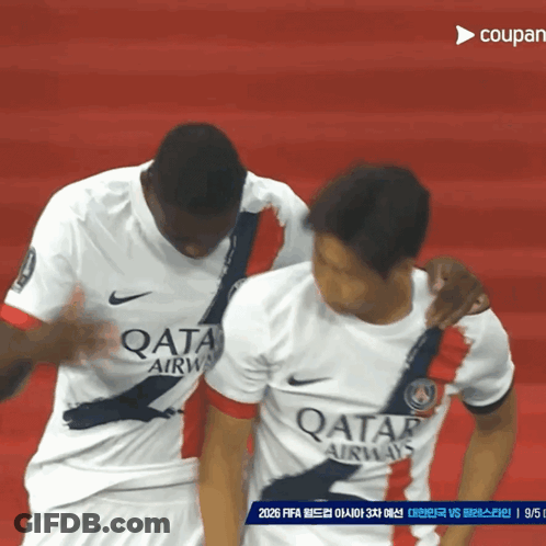 Two Soccer Players Wearing Qatar Airways Jerseys On A Red Field GIF
