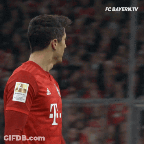 Two Soccer Players Wearing Red Shirts With The Letter T On The Front GIF