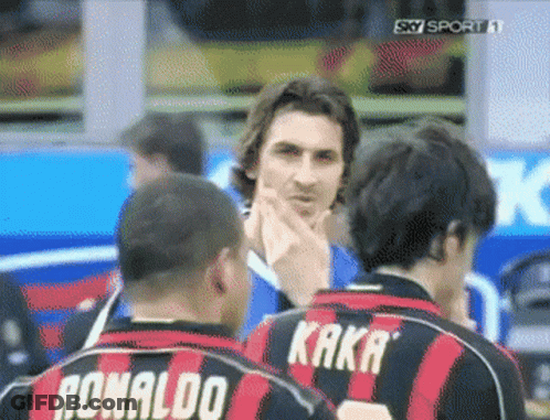 Two Soccer Players Wearing Ronaldo And Kaka Jerseys Are Talking To Each Other GIF