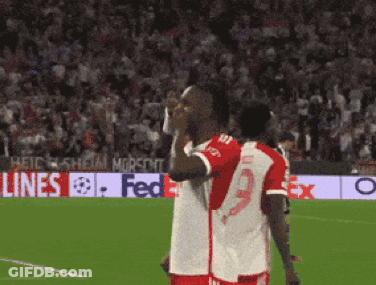 Two Soccer Players With FedEx Banner GIF