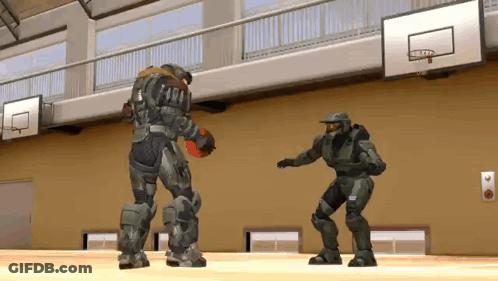 Two Soldiers Are Playing Basketball In A Gym And One Of Them Is Holding A Basketball . GIF