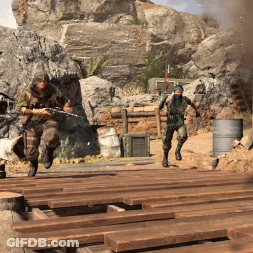 Two Soldiers Are Running Across A Wooden Bridge With A Barrel In The Background That Says ' Reichspartei ' On It GIF