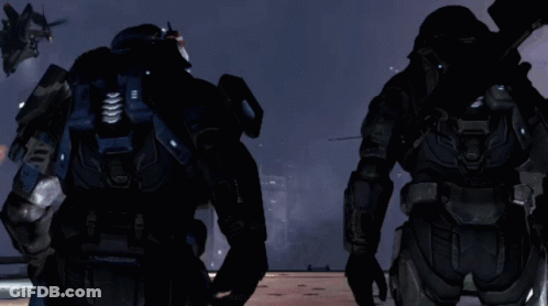 Two Soldiers Are Standing In Front Of A Helicopter With A Message That Says " Move To Ground " On The Screen GIF
