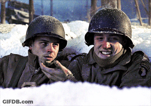 Two Soldiers Are Talking In The Snow And One Has A Patch On His Uniform That Says ' Army ' GIF