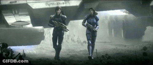 Two Soldiers Are Walking In Front Of A Ship That Says M4u GIF