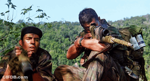 Two Soldiers One Of Whom Is Holding A Sniper Rifle With The Letter R On It GIF