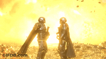 Two Soldiers Standing In Front Of Fire GIF