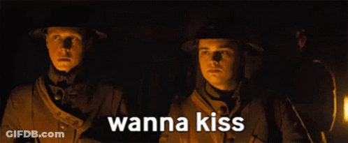 Two Soldiers Standing Next To Each Other With The Words Wanna Kiss Written On The Bottom GIF