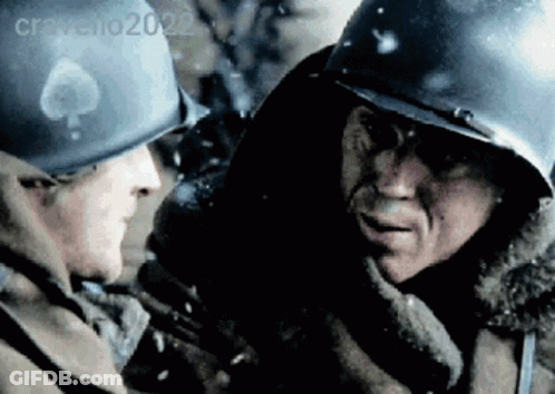 Two Soldiers Wearing Helmets Are Talking To Each Other In A Blurry Photo Taken By Cravello2022 GIF