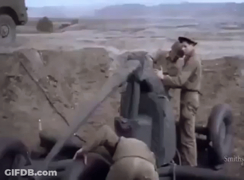 Two Soldiers Working On Cannon GIF