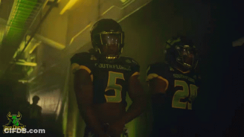 Two South Florida Football Players In Dark Locker Room GIF