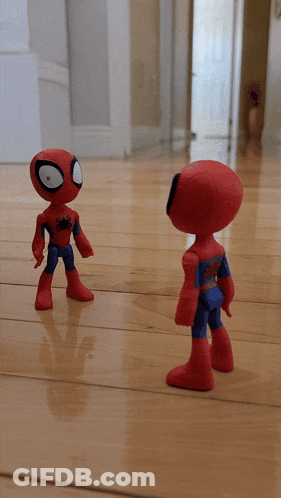 Two Spider Man Action Figures On A Wooden Floor GIF