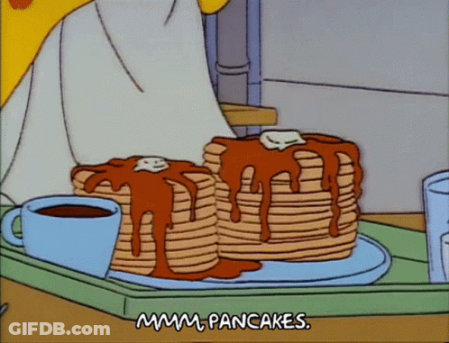 Two Stacks Of Pancakes Are On A Tray With A Cup Of Coffee GIF
