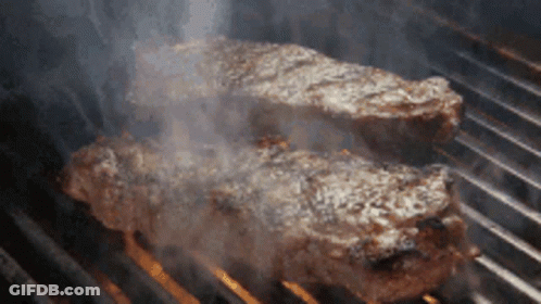 Two Steaks Cooking On Grill GIF
