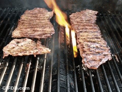Two Steaks On Grill With Flames GIF