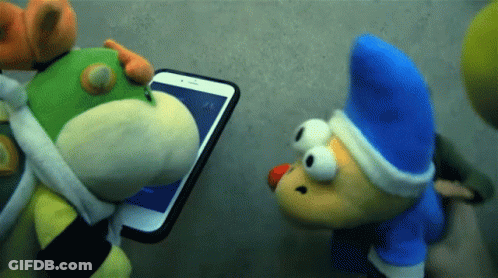 Two Stuffed Animals Are Looking At A Cellphone GIF