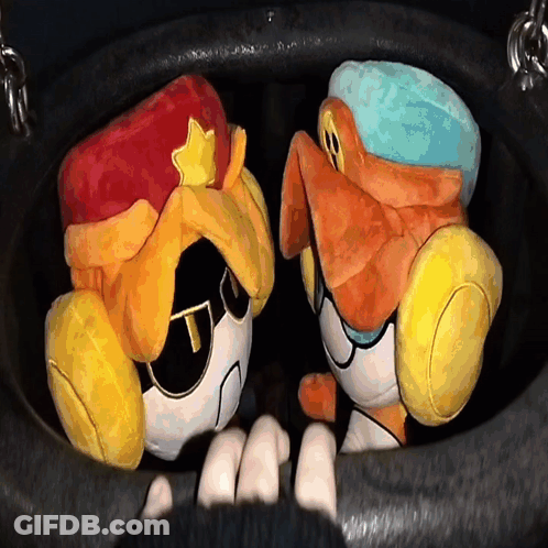Two Stuffed Animals Are Sitting In A Black Bucket GIF