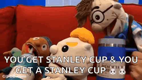 Two Stuffed Animals Are Sitting On A Couch And One Of Them Is Holding A Stanley Cup GIF