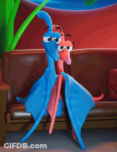 Two Stuffed Animals Are Sitting On A Couch In Front Of A Tv GIF