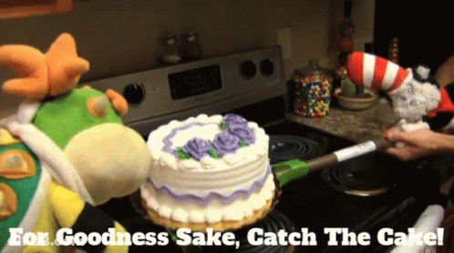 Two Stuffed Animals Are Standing Next To A Cake On A Stove With The Words " For Goodness Sake Catch The Cake " Below The GIF