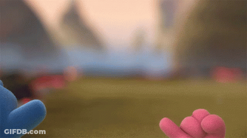 Two Stuffed Animals Are Standing Next To Each Other In A Field GIF