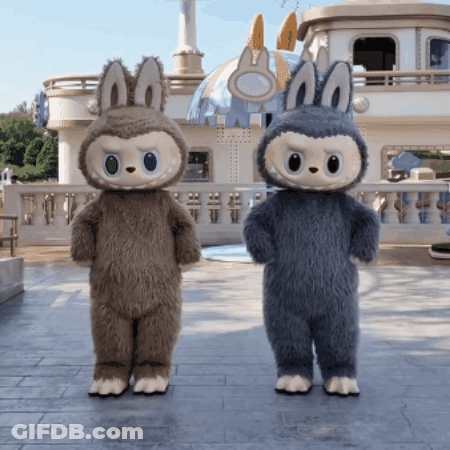 Two Stuffed Animals Are Standing Next To Each Other GIF