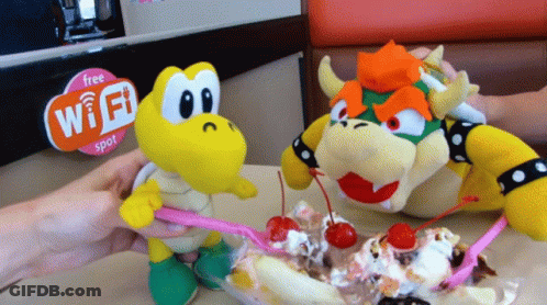 Two Stuffed Animals Eating Ice Cream Next To A Sign That Says Free Wi-Fi Spot GIF
