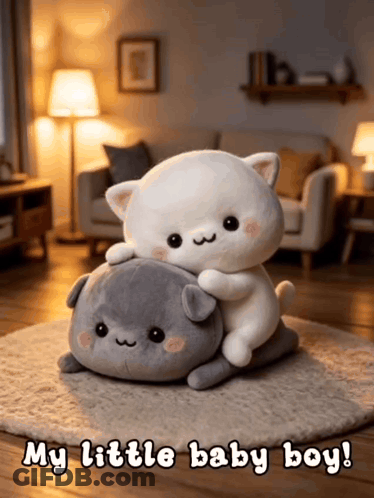 Two Stuffed Animals Laying On Top Of Each Other With The Words " My Little Baby Boy " Above Them GIF
