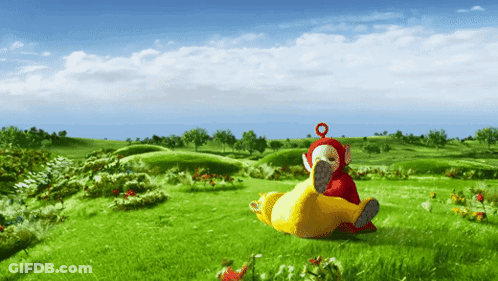 Two Stuffed Animals Lying In Grass GIF