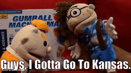 Two Stuffed Animals Next To Gumball Machine Box GIF