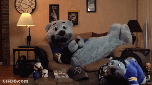 Two Stuffed Animals On Couch, One Wearing Blues Hat GIF
