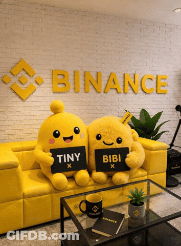 Two Stuffed Animals On Yellow Couch Holding Tiny And Bibi Signs GIF