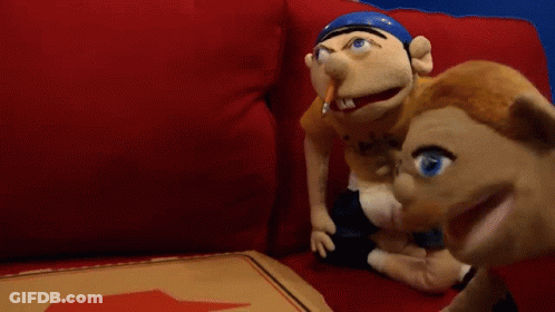 Two Stuffed Animals Sit On A Red Couch Next To A Pizza Box GIF