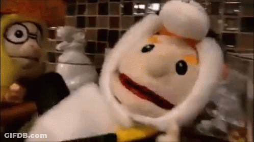 Two Stuffed Animals Standing Next To Each Other On Counter GIF