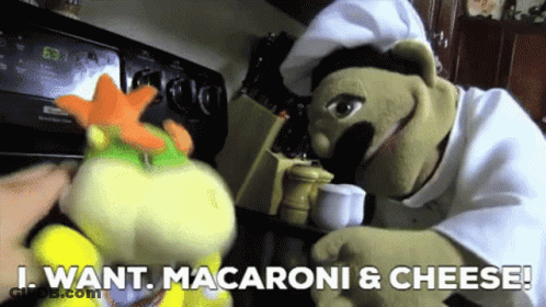 Two Stuffed Animals Standing Next To Each Other With The Words " I Want Macaroni & Cheese " On The Bottom GIF